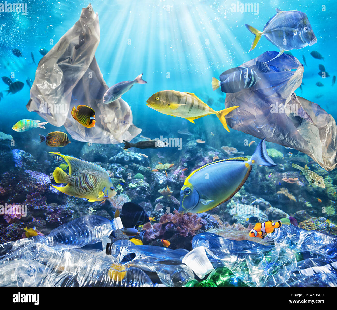 Fishes swims with floating bags. Problem of plastic pollution under the sea concept. Stock Photo