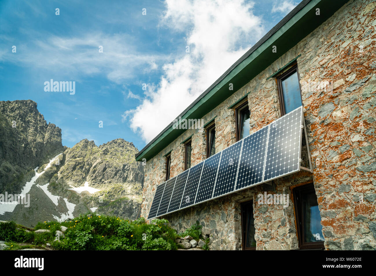 Solar panels installed on mountain house walls in High Tatras, Slovakia Stock Photo