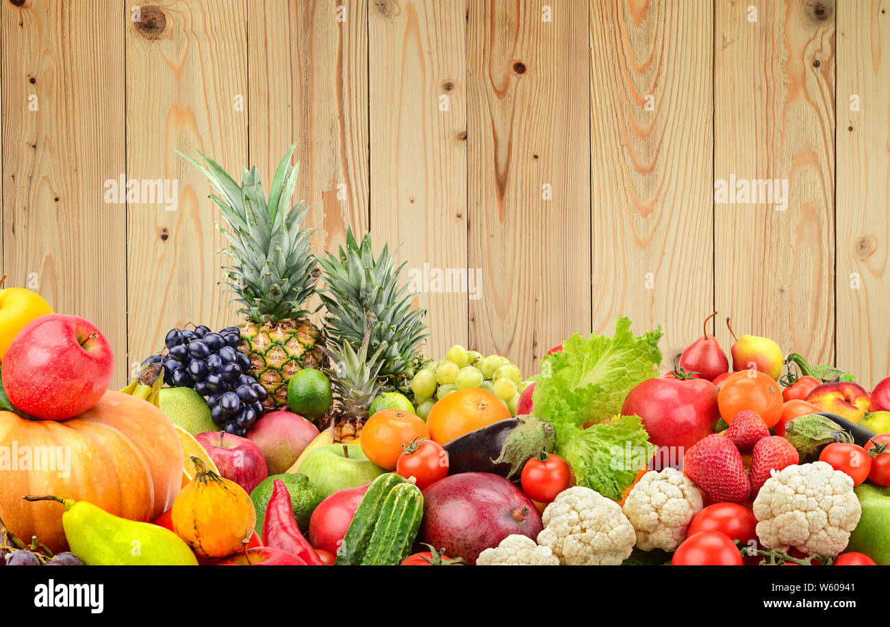 Panoramic photo healthy vegetables and fruits against wooden wall. Free space for text. Stock Photo