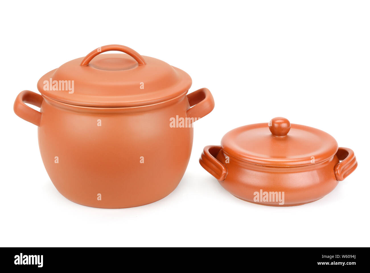 Two clay pots with lids isolated on white background Stock Photo - Alamy