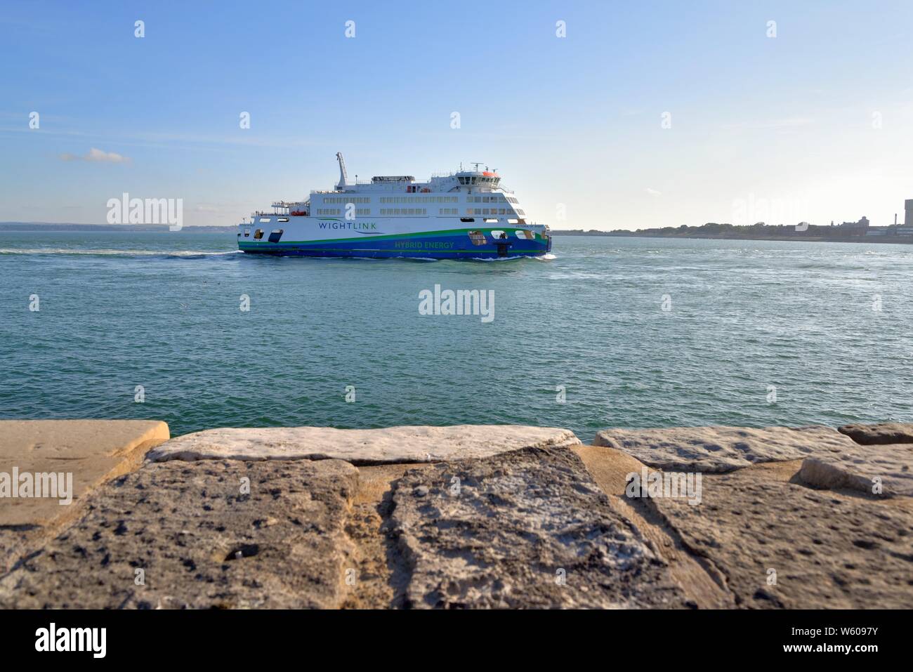 The Wightlink hybrid car and passenger ferry Victoria of Wight sailing into Portsmouth harbour on a summers evening, Hampshire England UK Stock Photo