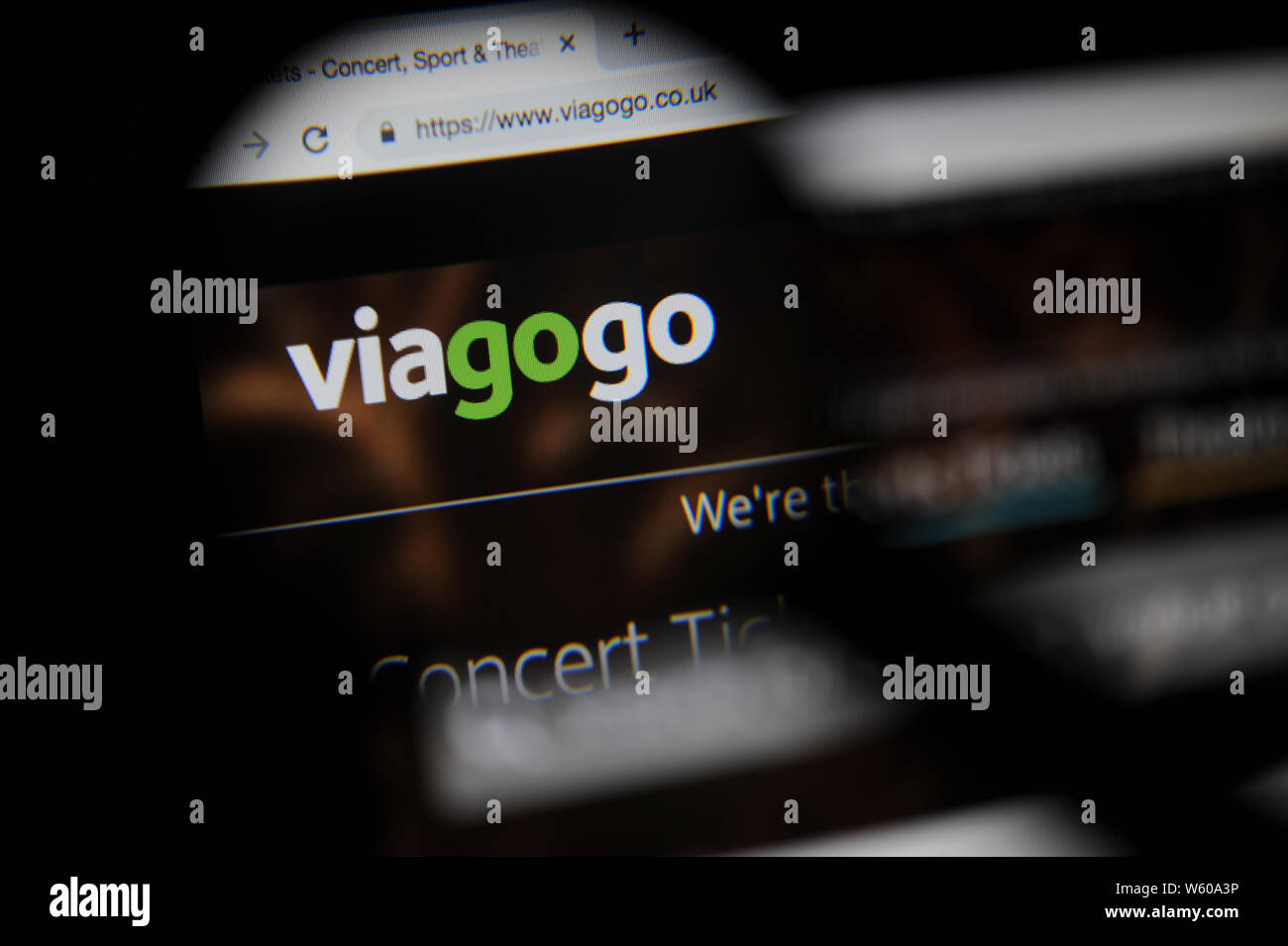 Viagogo website seen through a magnifying glass Stock Photo