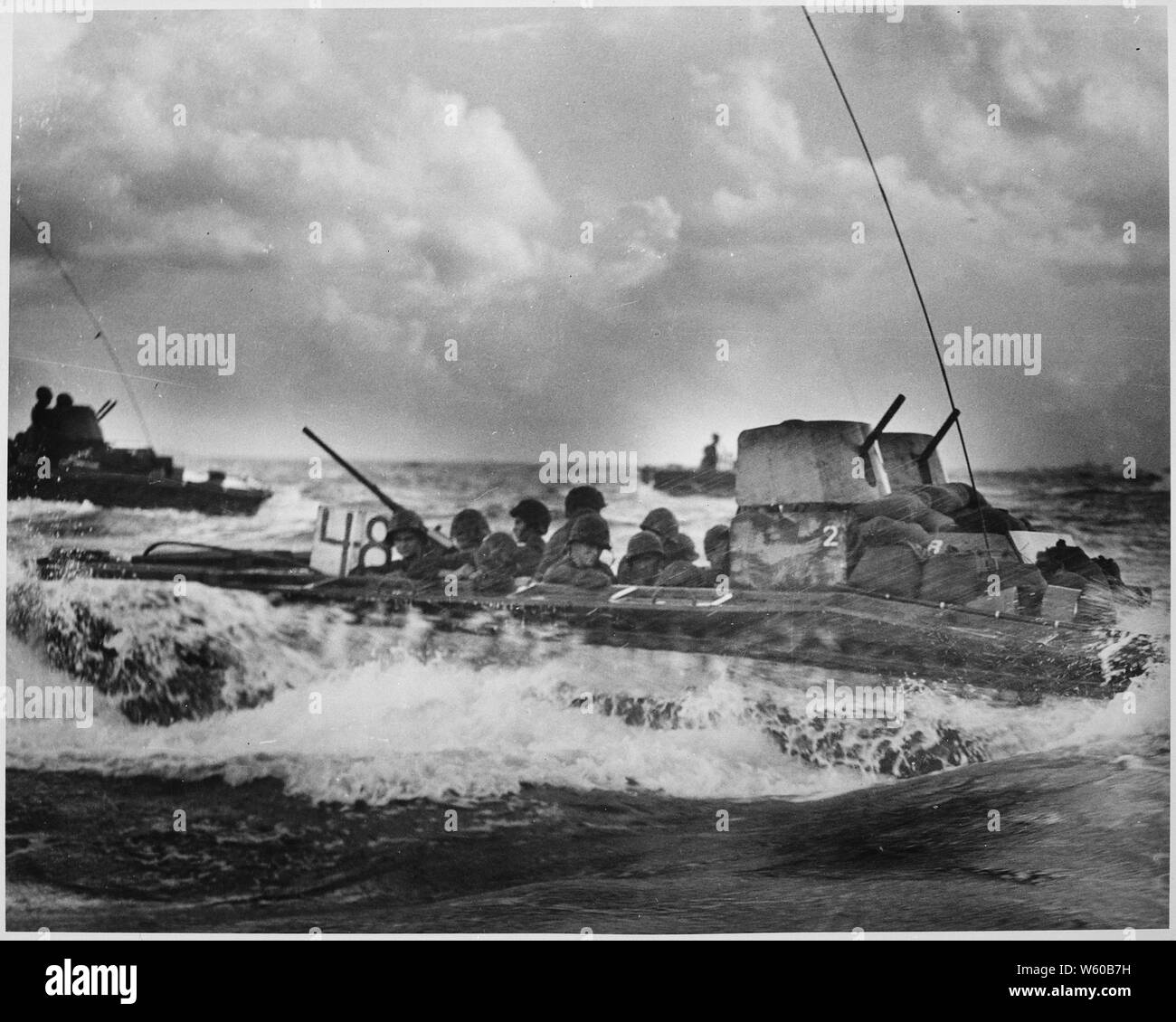 A Water Buffalo, loaded with Marines, churns through the sea bound for beaches of Tinian Island near Guam.; General notes:  Use War and Conflict Number 1165 when ordering a reproduction or requesting information about this image. Stock Photo