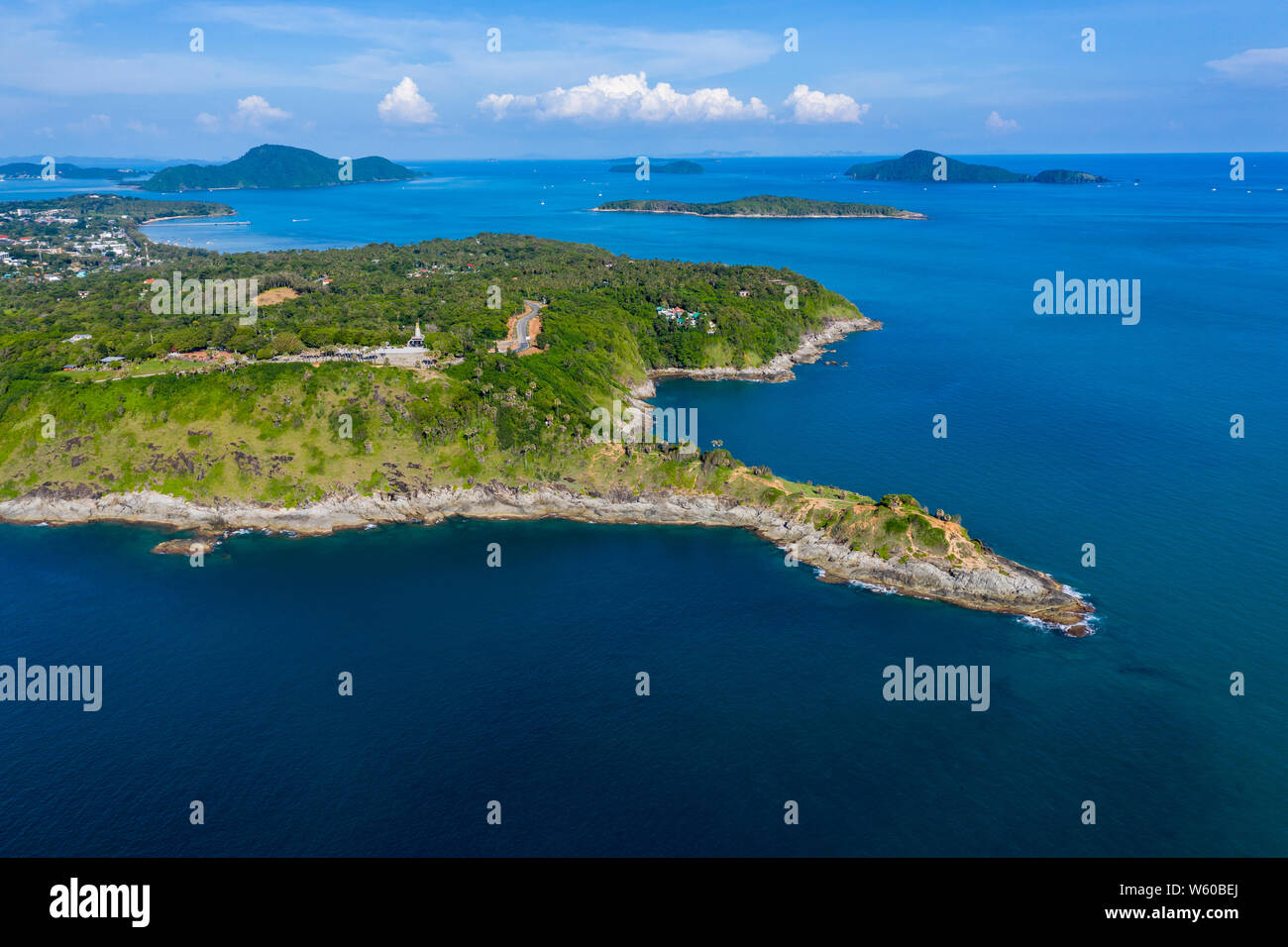 Aerial drone view of a rocky peninsula and a calm, tropical ocean Stock Photo