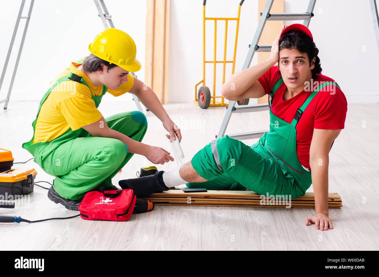 The injured worker and his workmate Stock Photo - Alamy