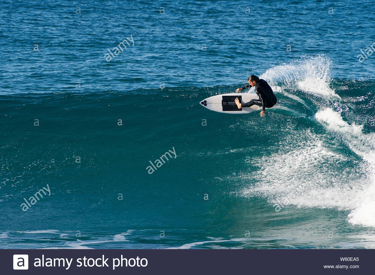 A Male Surfer Performing A Frontside Top Turn On A Nice