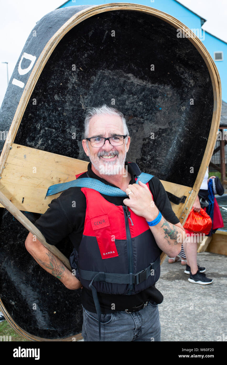 Radio presenter Andrew 'Tommo' Thomas takes a coracle down to the river at the Carmarthen River Festival 2019. Stock Photo