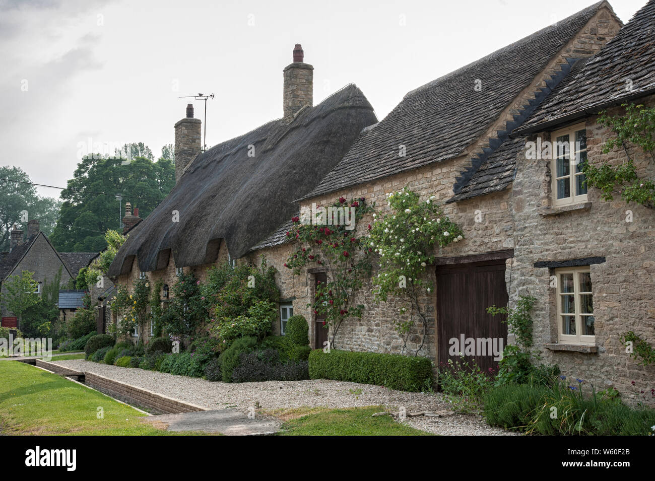 Narrow lane with romantic thatched houses and stone cottages in the