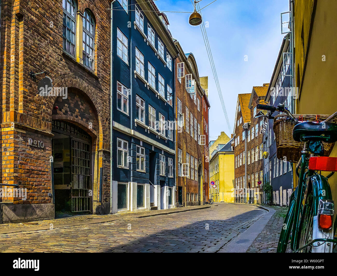July 29, 2019: Copenhagen, Denmark: A bicycle parked on a quiet back alley of Copenhagen city center on a fine summer day Stock Photo
