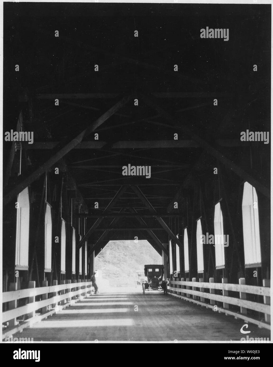 Alsea River Bridge, Station 60, Section 9. Looking through spans from South end. Shows stiff construction and well lighted roadway.; Scope and content:  Alsea River Forest Highway, Alsea River and Scott Creek Bridges. Stock Photo