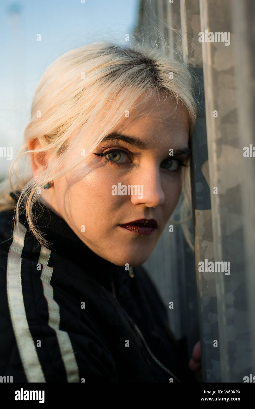 Young woman with urban clothes near the railings of the train. Stock Photo