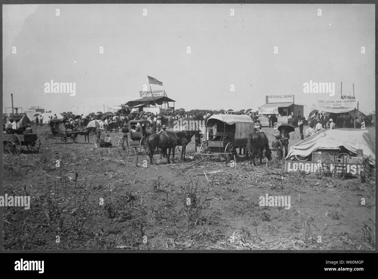 Anadarko Townsite, August 8, 1901. Auction in progress in lumber company booth. Temporary bank buildings and the beginnings of a lodging house nearby Stock Photo