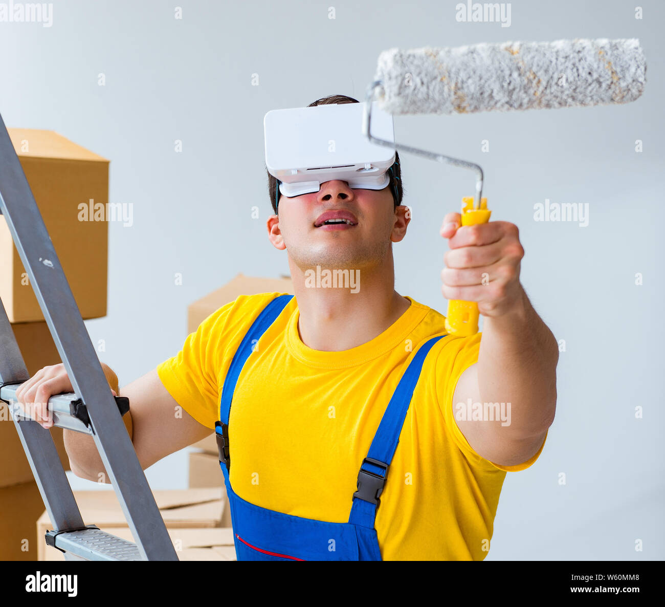 The painter contractor working with virtual reality goggles Stock Photo