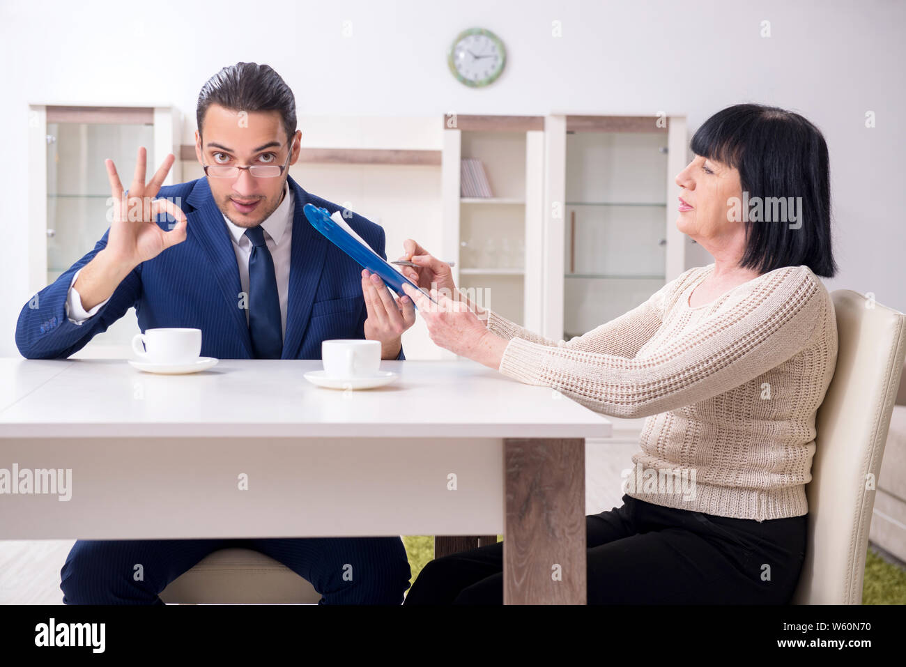 The male real estate agent and female client in the apartment Stock