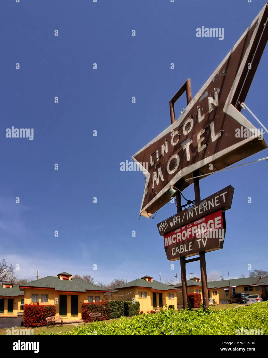 The Lincoln Motel vintage neon sign in Chandler Oklahoma is off-set by blue sky. Stock Photo