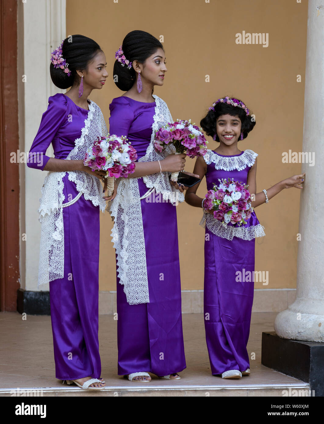 Kandy, Sri Lanka - 09-03-24 - Two Women and Girl Wait for Wedding Couple. Stock Photo