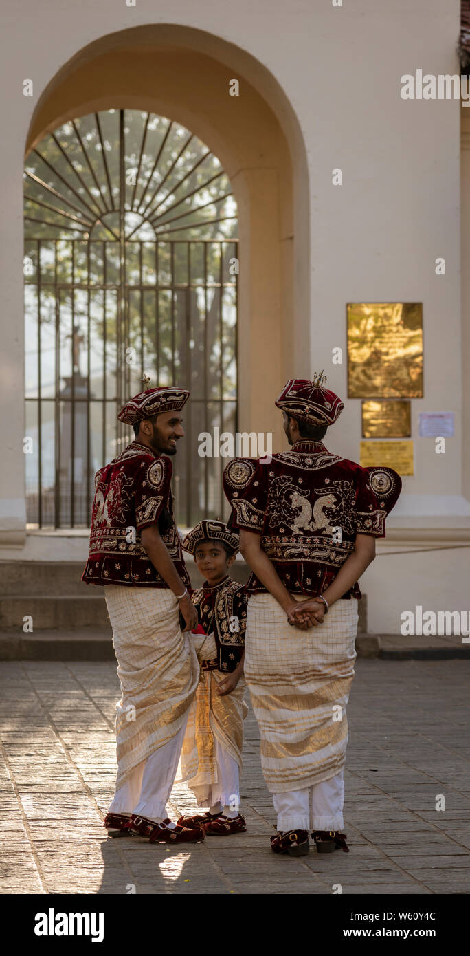 Kandy, Sri Lanka - 09-03-24 - Two Men and a Boys Wait for Wedding Couple. Stock Photo