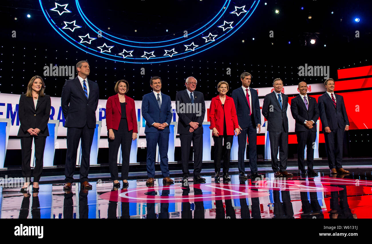 Detroit, Michigan, USA. 30th July, 2019. From left, MARIANNE WILLIAMSON, TIM RYAN, AMY KLOBUCHAR, PETE BUTTIGIEG, BERNIE SANDERS, ELIZABETH WARREN, BETO O'ROURKE, JOHN HICKENLOOPER, JOHN DELANY and STEVE BULLOCK take their places for the photo spray at the first of two Democratic Debates in Detroit hosted by CNN and sanctioned by the DNC. Credit: Brian Cahn/ZUMA Wire/Alamy Live News Stock Photo