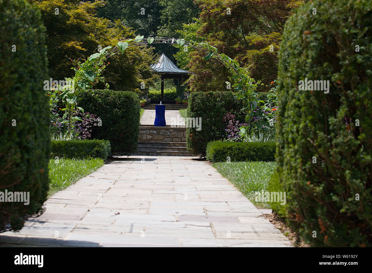 Entrance to flower garden with arch and trellis Stock Photo Alamy