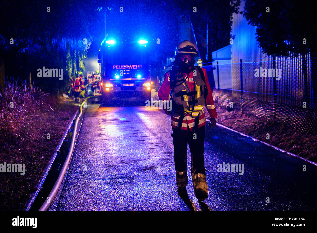 Rastede, Germany. 31st July, 2019. Firefighters are on duty in a warehouse fire. The fire had been discovered shortly after midnight by an employee in the paint factory, a spokesman for the fire brigade said. In the meantime, however, the fire is under control. Credit: Mohssen Assanimoghaddam/dpa/Alamy Live News Stock Photo