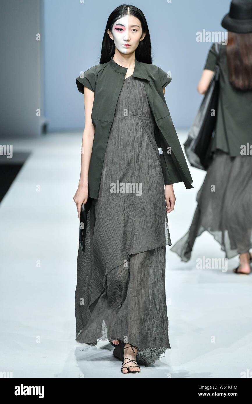 A model displays a new creation at the fashion show of MOUSE JI SGM ART ...