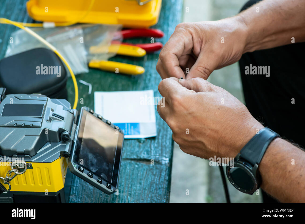 Device for mounting optical cable. Optical internet Technology concept. Optical fiber assembly. Stock Photo