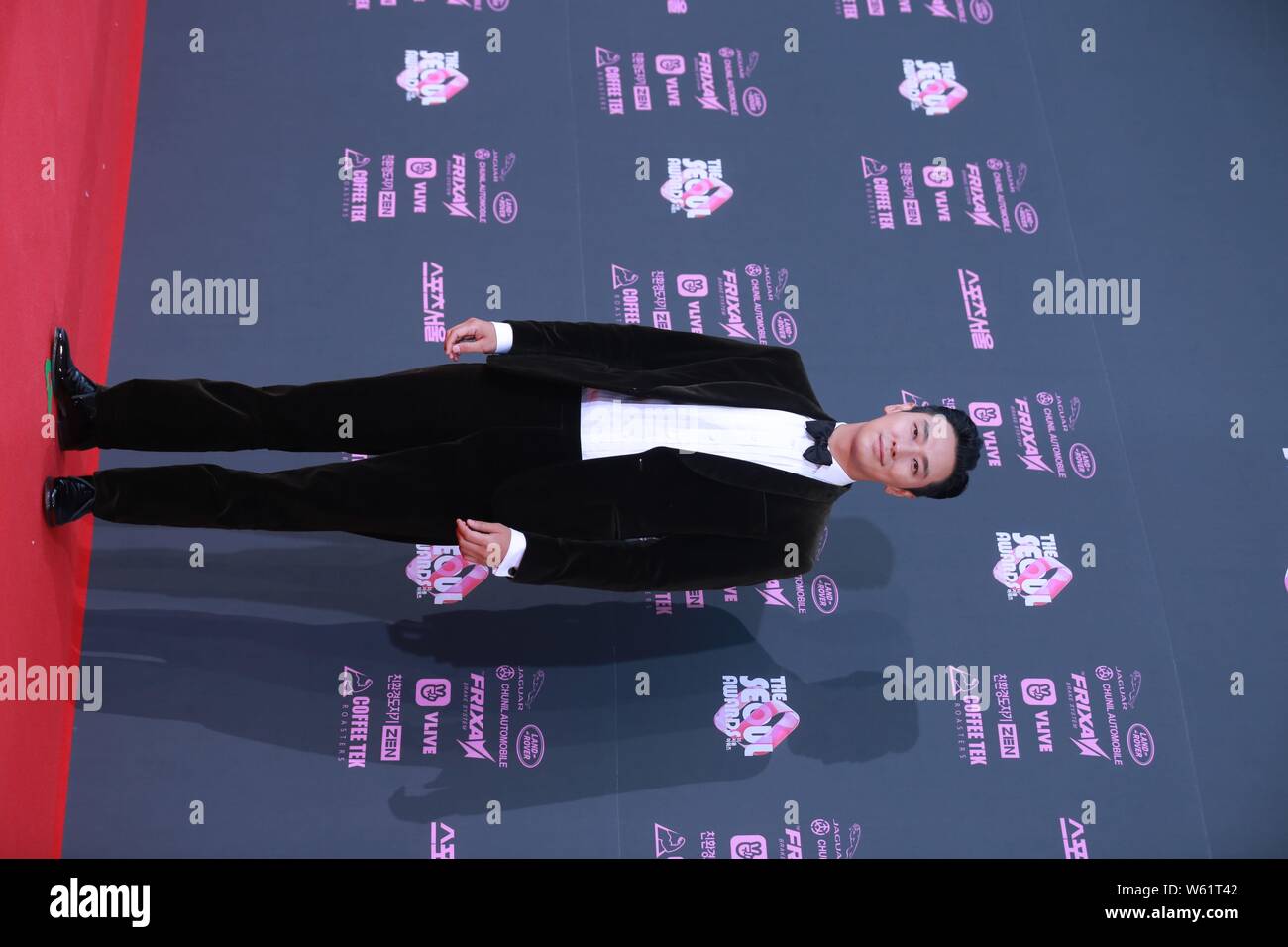 South Korean actor Ju Ji-hoon poses as he arrives on the red carpet for the 2nd 'The Seoul Awards' in Seoul, South Korea, 27 October 2018. Stock Photo