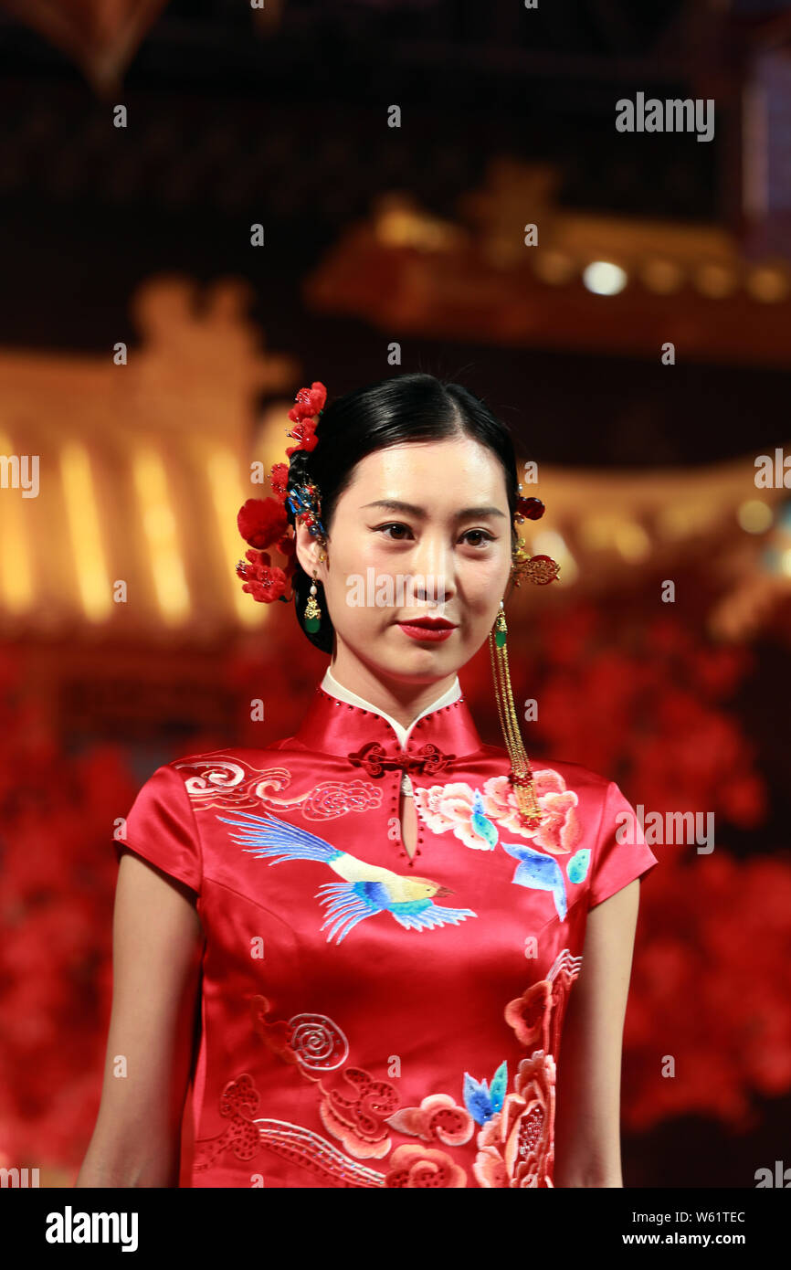 A model displays a traditional Chinese wedding dress at the 