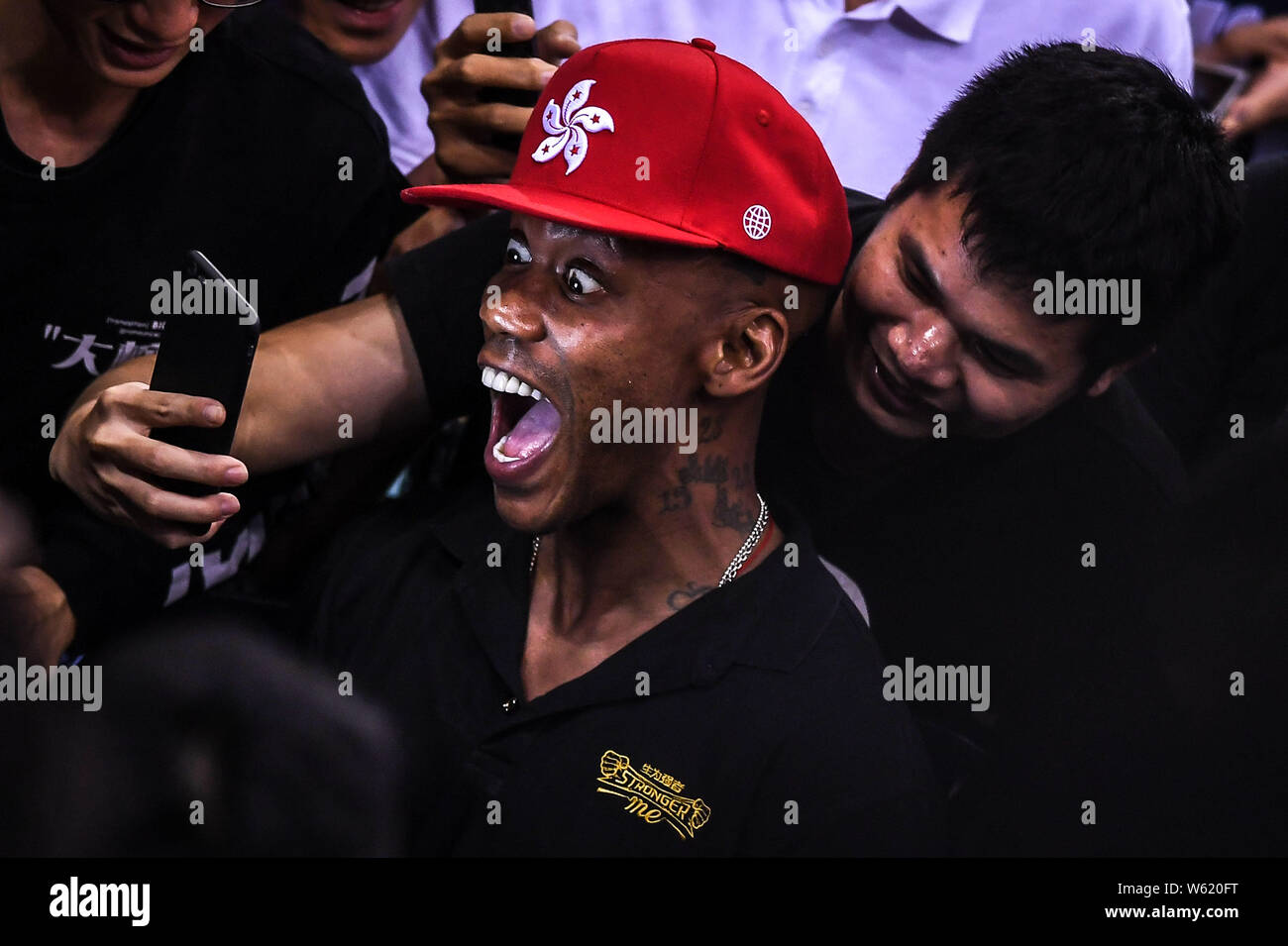 Retired NBA star Stephon Marbury reacts as he poses for a selfie with