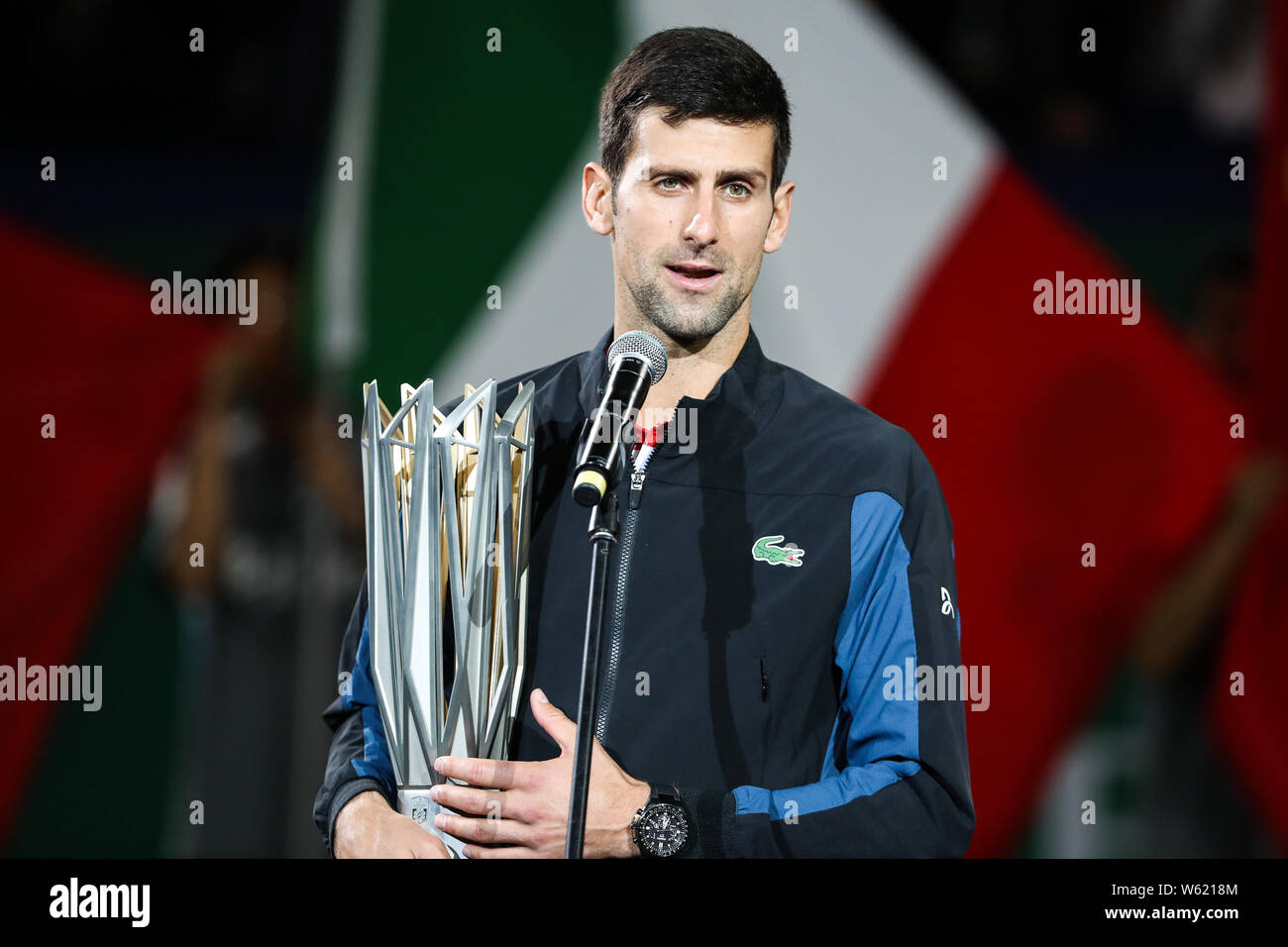 Novak Djokovic of Serbia holding his champion trophy speaks after
