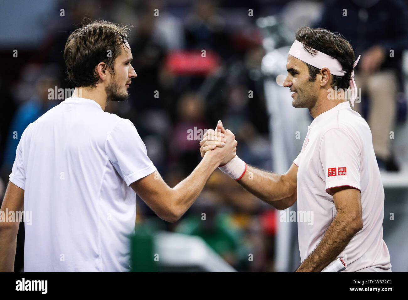 Roger Federer, right, of Switzerland shakes hands with Daniil Medvedev of Russia after their second round match of the men's singles during the Rolex Stock Photo