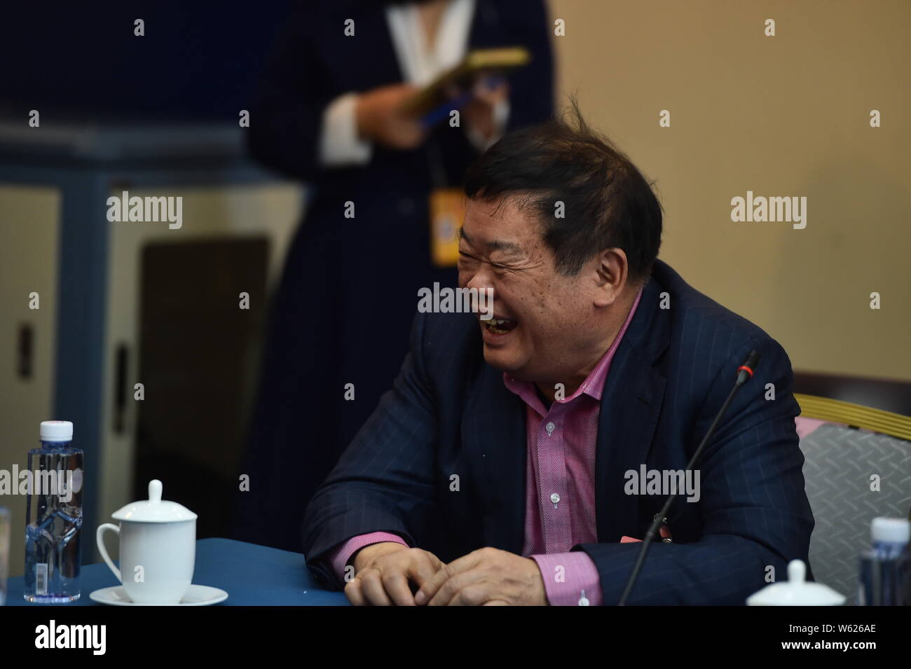 --FILE--Cho Tak Wong (Cao Dewang), Chairman of Fuyao Group and Chairman of Fuyao Glass Industry Group Co., attends a panel discussion during the Fifth Stock Photo