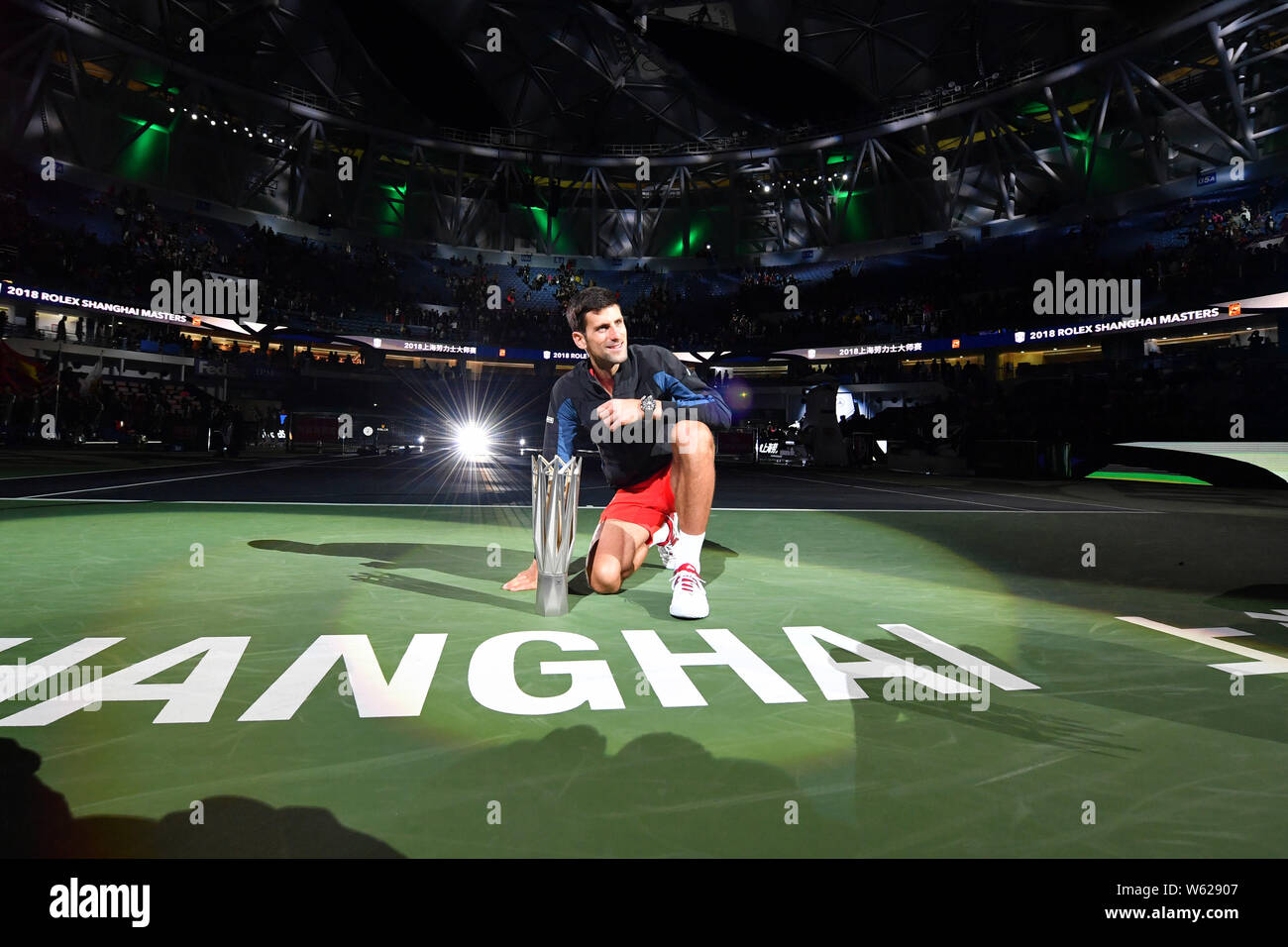 Novak Djokovic of Serbia poses with his champion trophy after defeating ...