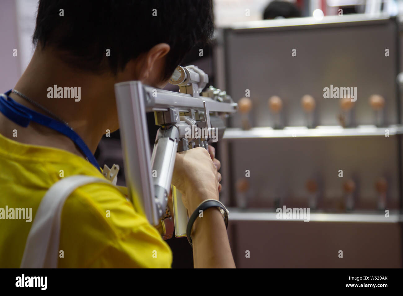 Man shooting aluminum light weight frame rubber band gun Stock Photo