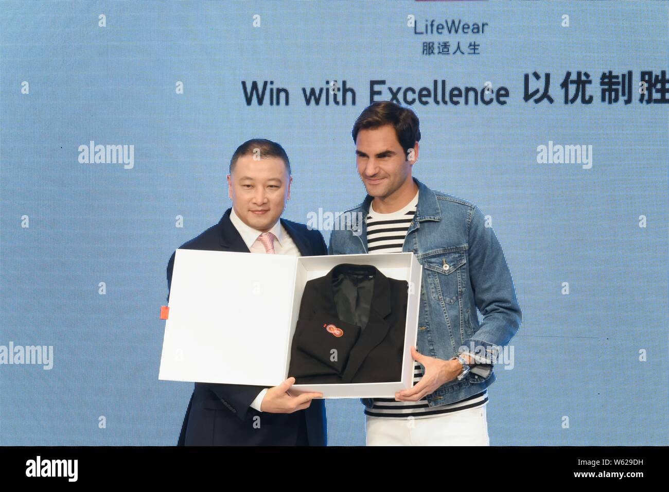 Swiss tennis star Roger Federer, right, attends a promotional event by Japanese fashion brand