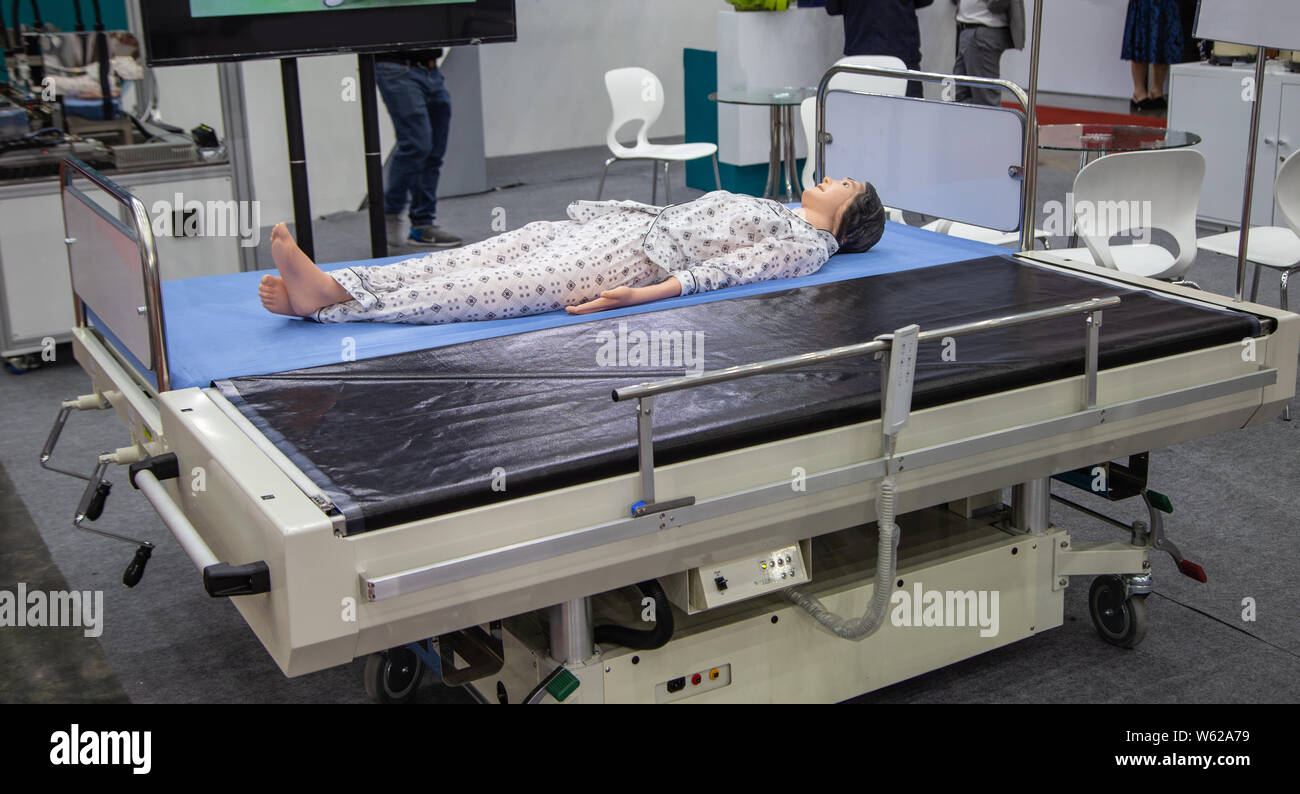 Patient dummy lying on automatic transfer hospital bed Stock Photo Alamy