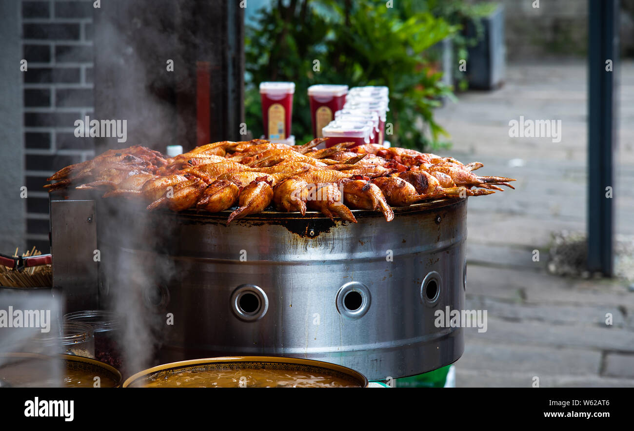 Barbeque Chicken wings stuffed with rice on Chinese food market Stock