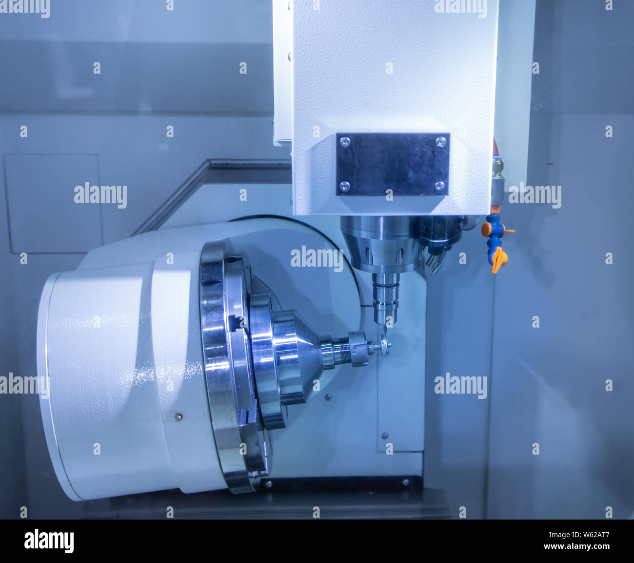 CNC milling machine cutting small gear part Stock Photo Alamy