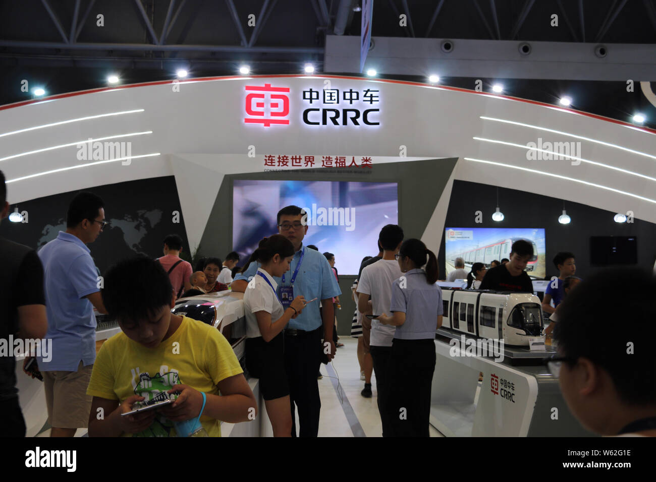--FILE--People visit the stand of CRRC (China Railway Rolling Stock Corp) during an expo in Chongqing, China, 23 August 2018.   CRRC Zhuzhou Locomotiv Stock Photo