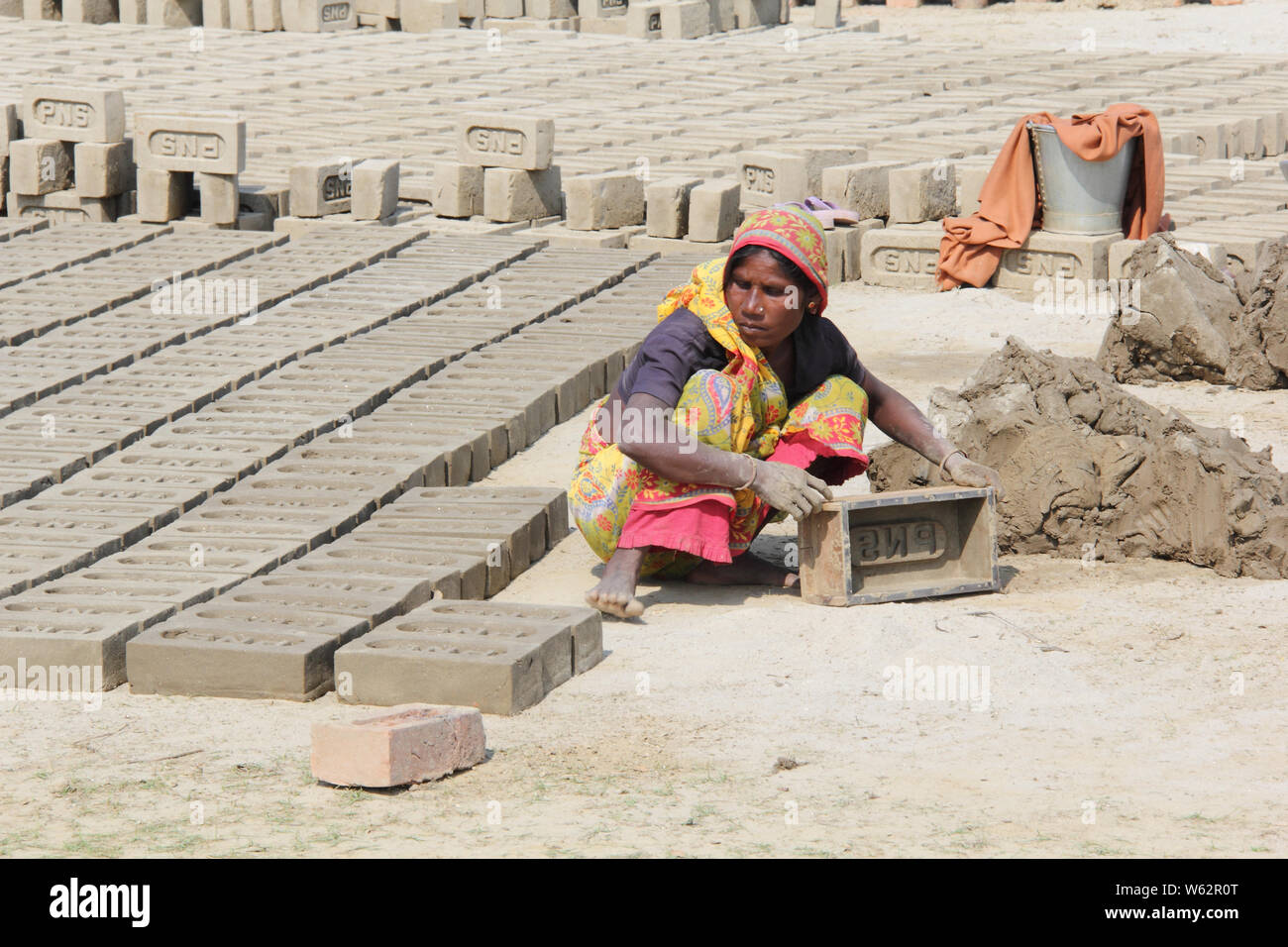 Woman making bricks Stock Photo