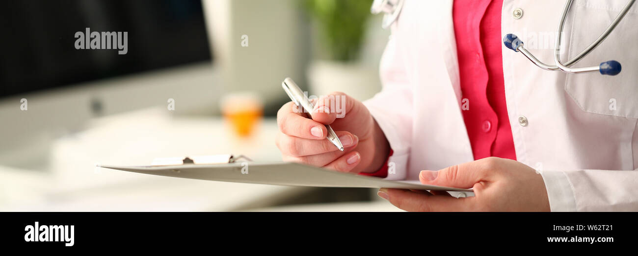 Doctor standing hold clipboard hi-res stock photography and images - Alamy