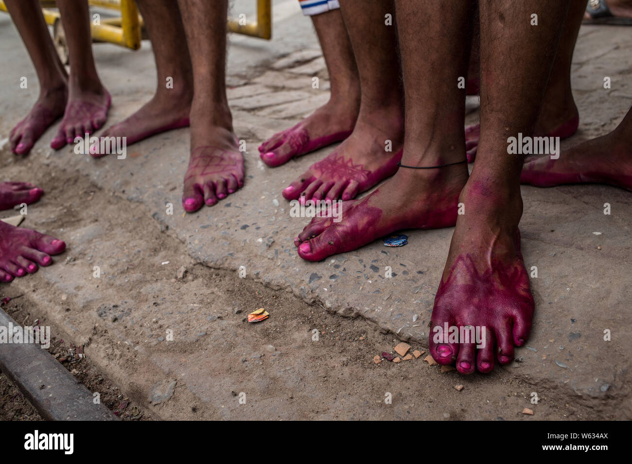 Close up of a bunch of hindu mens feet, coloured for a ceremony Stock Photo