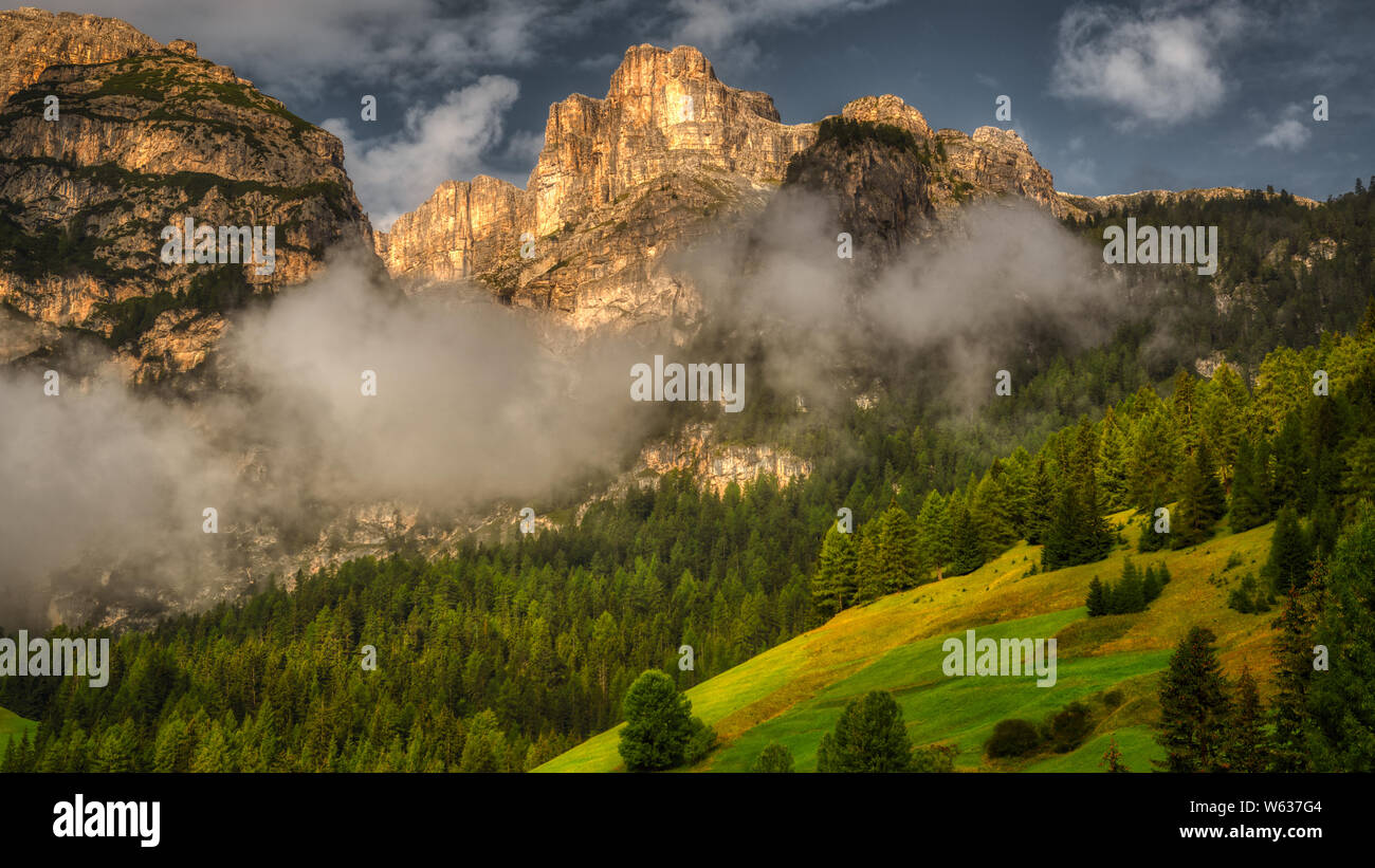 Sunlight over the top of mountains of Alta Badia Stock Photo