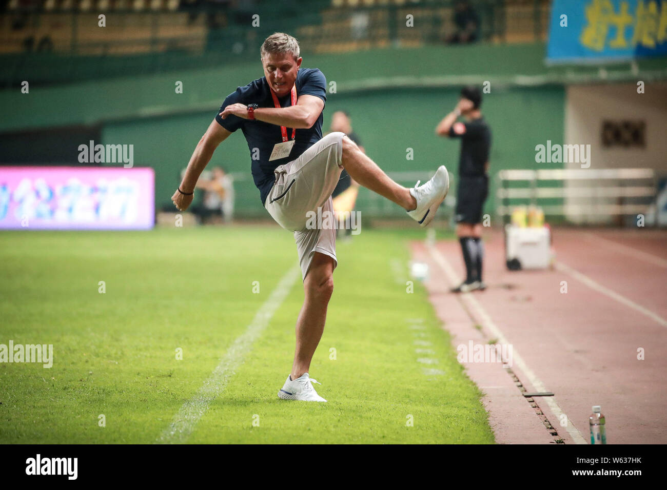 Head coach Dragan Stojkovic of Guangzhou R&F reacts as he watches his players competing against Chongqing SWM in their 23rd round match during the 201 Stock Photo
