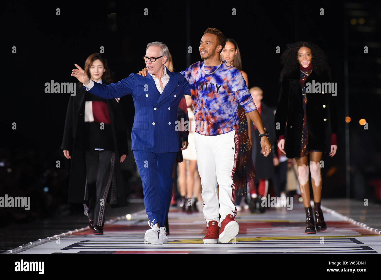 American fashion designer Tommy Hilfiger left and British racing driver Lewis Hamilton pose during the Tommy Hilfiger s TommyNow Icons Fall Winter 2 Stock Photo Alamy