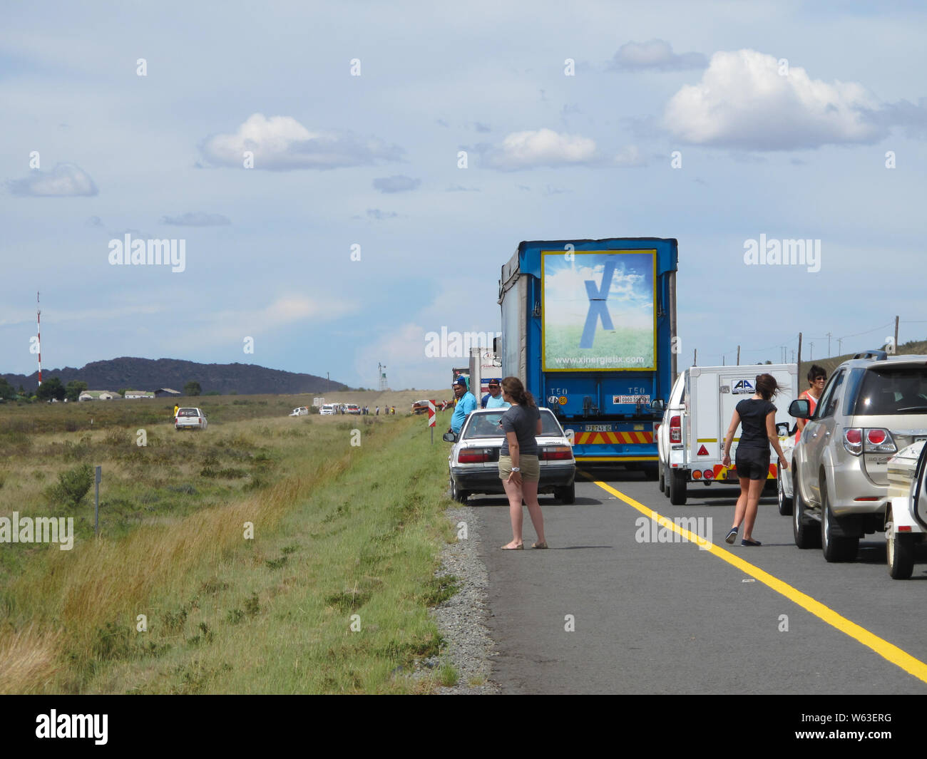 traffic jam and cars and trucks blocked on the highway due to a road accident with people taking a look at the chaotic scene in South Africa in Summer Stock Photo