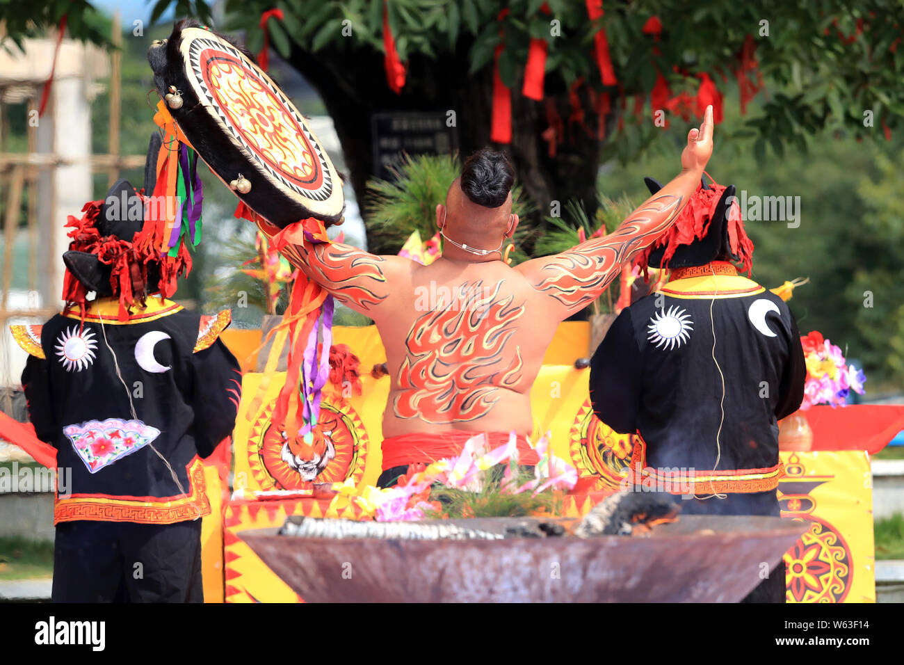 People of Yi ethnic group attend a walnut picking festival held in