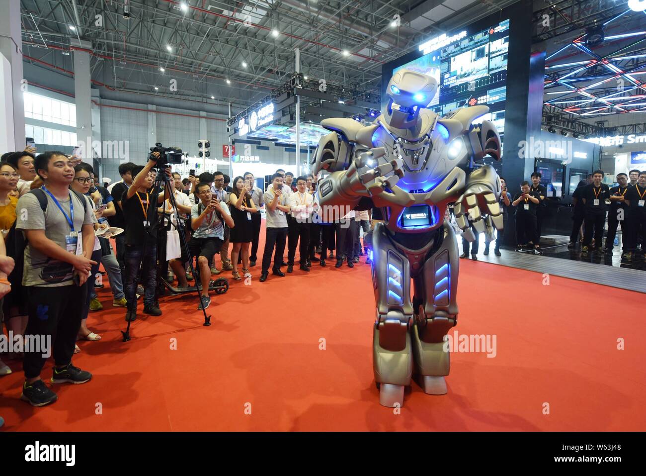 Chinese visitors view or take pictures of an intelligent robot of Shanghai  Tuxuan Robots Co., Ltd. during the 20th China International Industry Fair  Stock Photo - Alamy