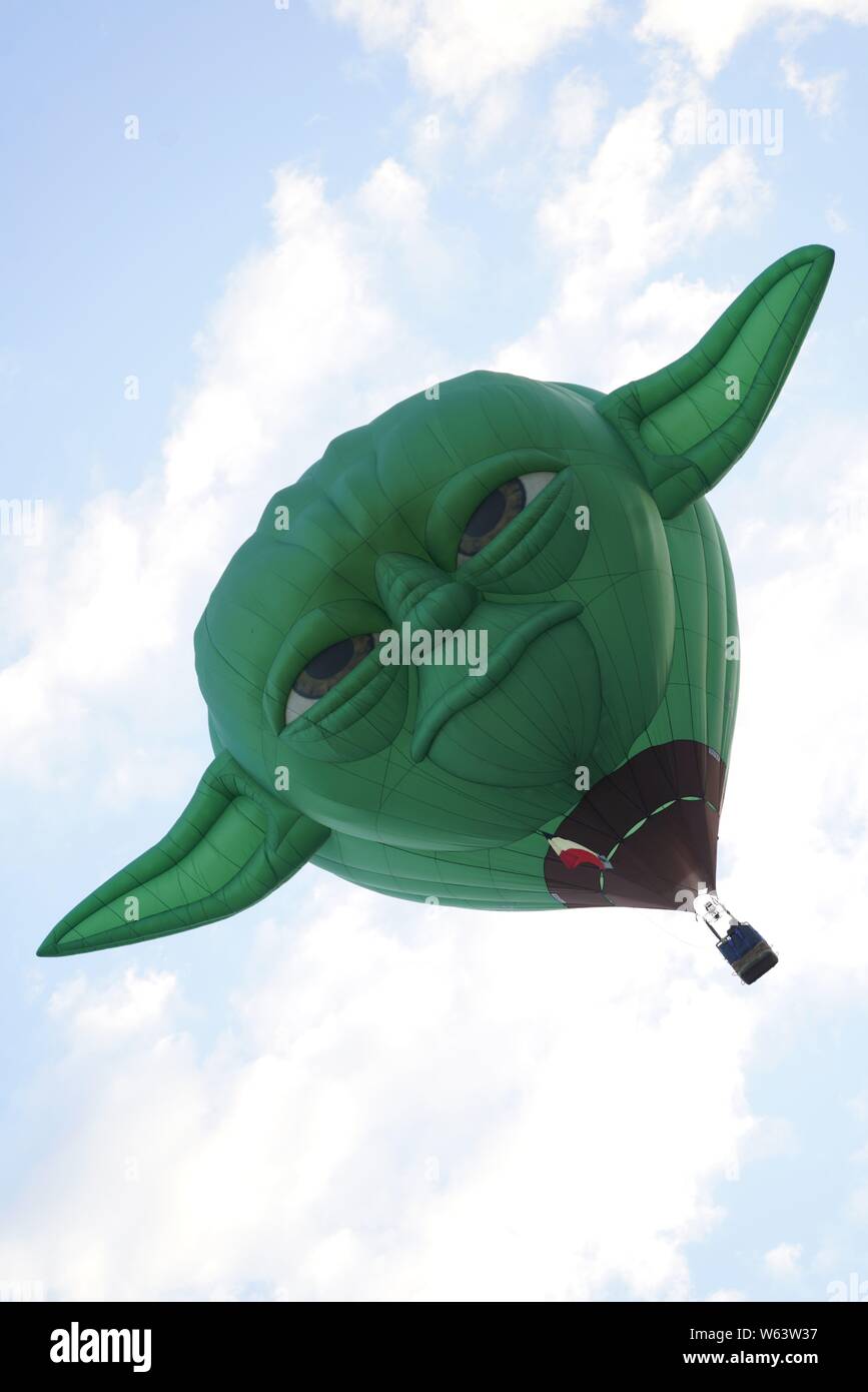 Hot air balloon resembling Yoda from star wars rising in the air. Stock Photo