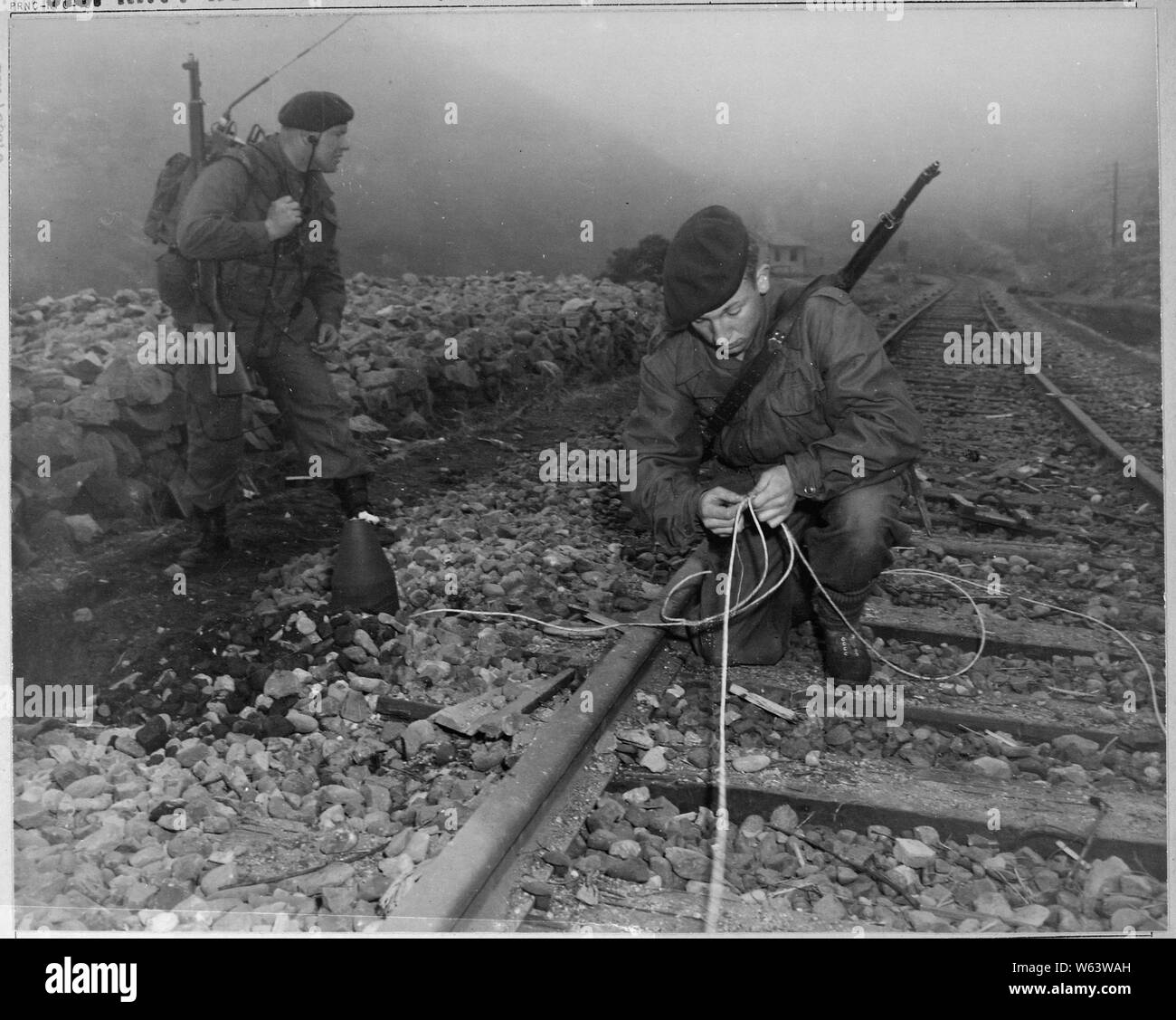 British Commandos of the 41st Royal Marines plant demolition charges along railroad tracks of enemy supply line which they demolished during a commando raid, 8 miles south of Songjin, Korea.; General notes:  Use War and Conflict Number 1434 when ordering a reproduction or requesting information about this image. Stock Photo